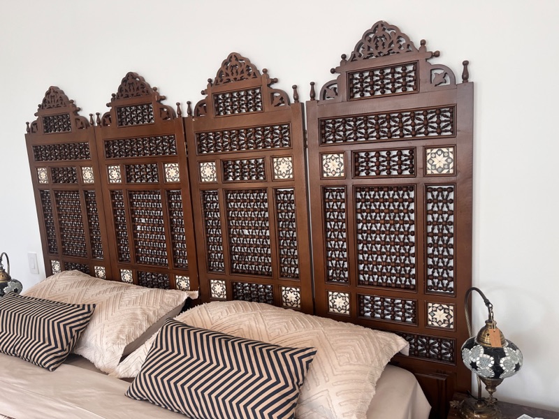 The folding screen seen at an angle, the panels stepped apart.