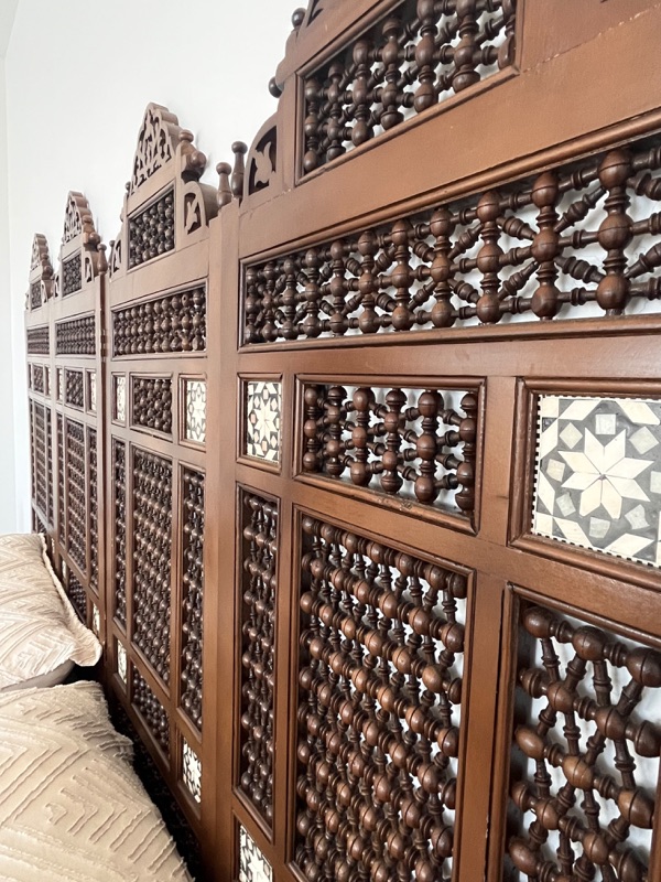 The screen photographed full height, the carved crest along its top edge.