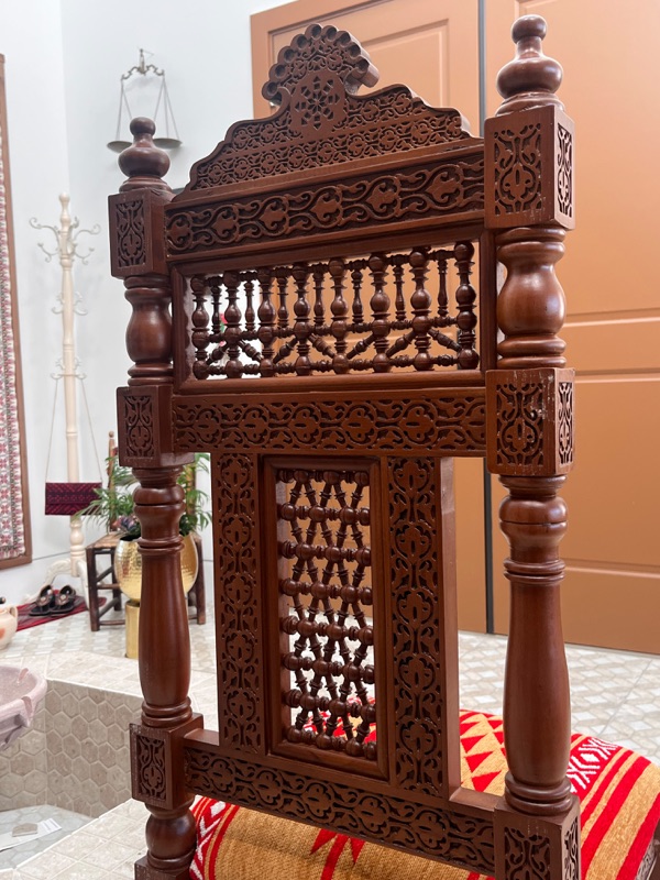 Two chairs side by side, showing the consistency of the carving across the set.